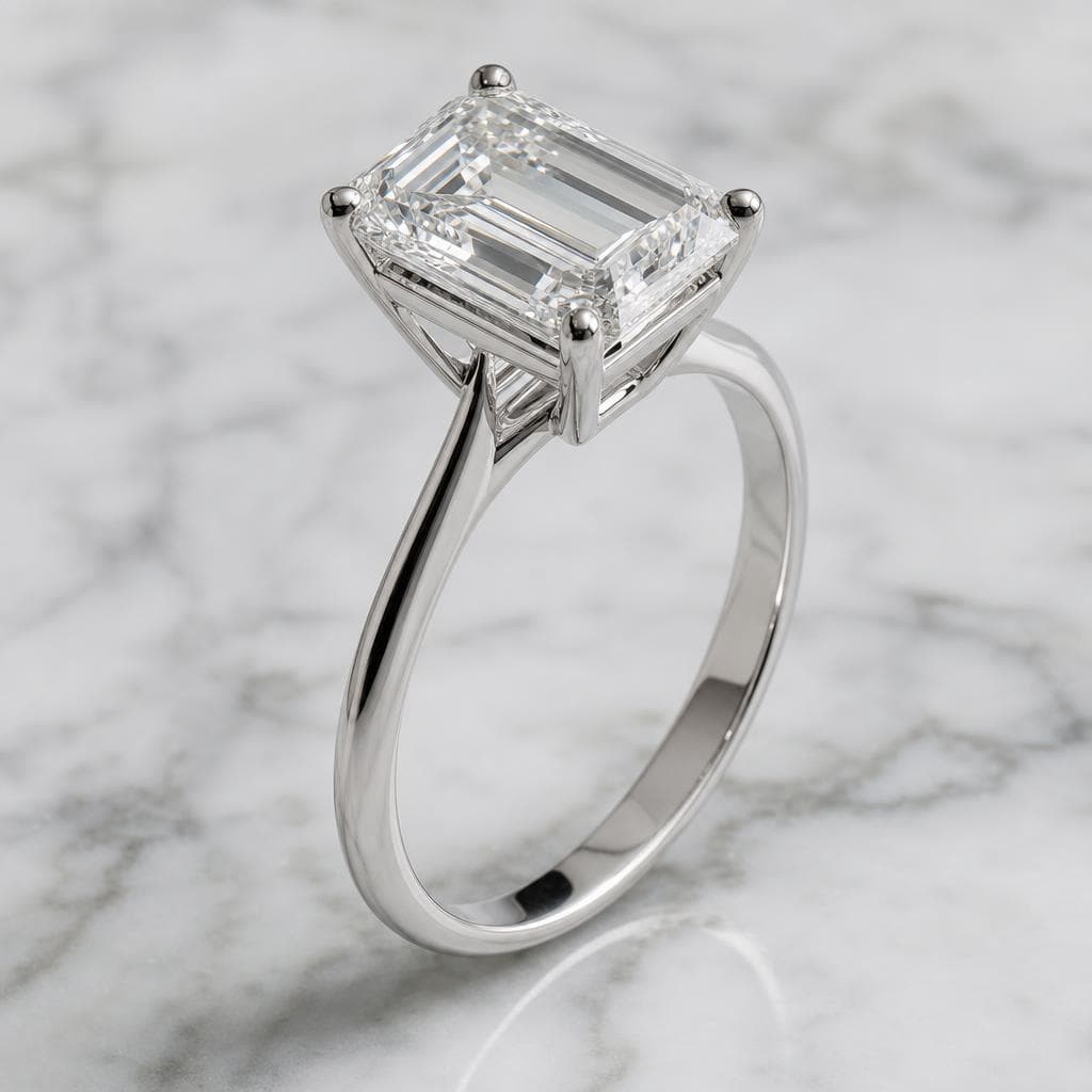 Macro product shot of an emerald-cut diamond ring on marble