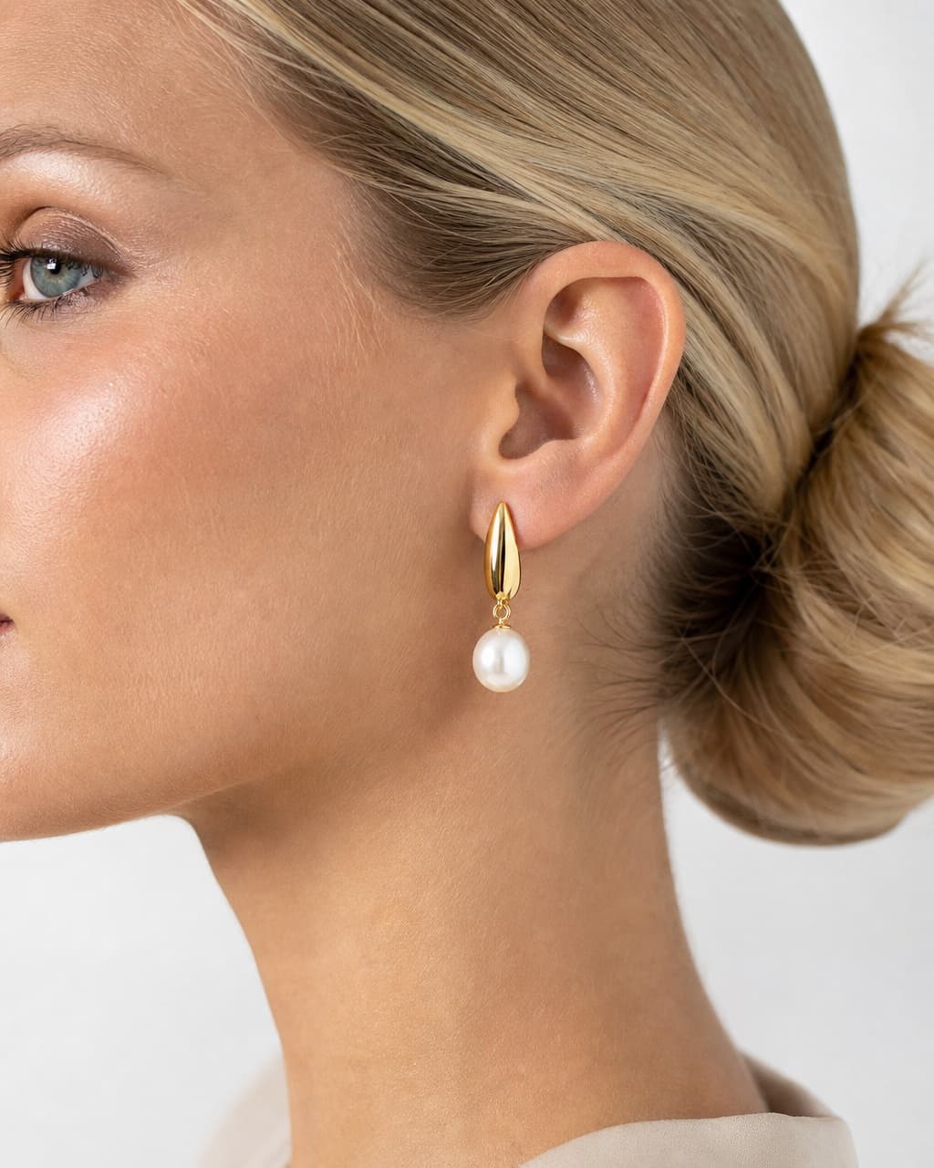 Try-on profile of a woman wearing a pearl drop earring